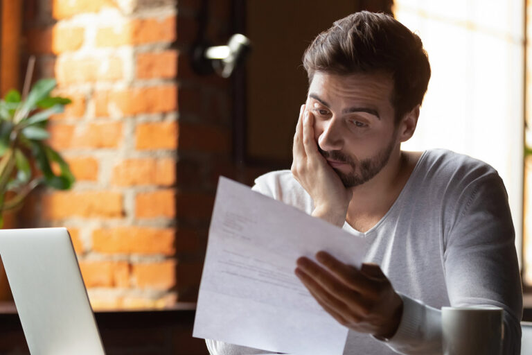 pessoa preocupada revisando documentos de trabalho
