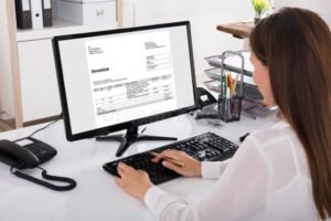 pessoa utilizando computador com nota fiscal